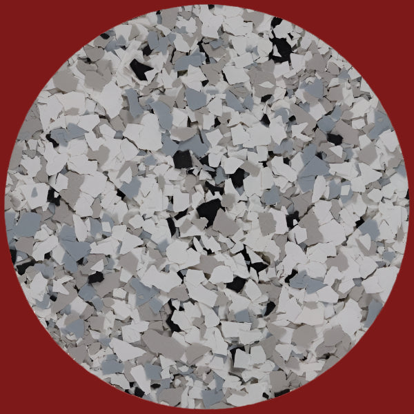 A close-up view of a sample texture of PVA Flakes featuring a blend of gray, black, and white colors.